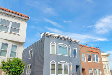 Suburban houses with pastel colors exterior in a low angle view in San Francisco, California