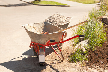 Wheelbarrow with gravel at the construction site