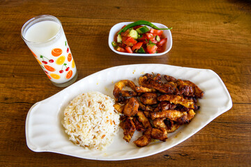 A skewered chicken kebob with grilled onions, bell peppers and delicious white meat with seasoning isolated on a white background. Tavuk sis, Tavuk izgara.