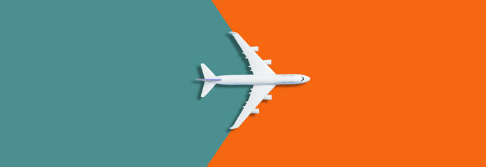 Flat lay design of travel concept with plane on orange background with copy space © Angelov