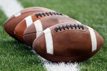 American footballs on grass