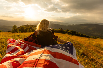 young beautiful woman holding USA flag.