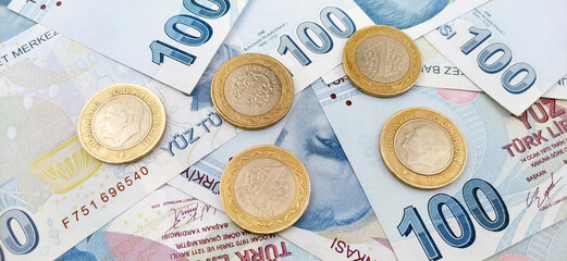 Close up view of one hundred Turkish lira banknotes with coins.