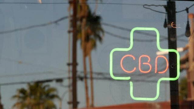 Neon sign in smoke shop, legalized cbd oil or medical cannabis in store, California USA. Legal sale of cannabidiol, weed, hemp, marijuana, ganja or hashish in dispensary. Cannabinoids in drugstore.