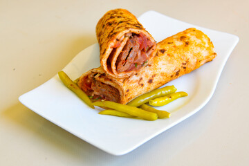 Grilled Turkish Adana, Urfa  Kebab with grilled vegetables, onion and rice on plate. Adana durum.