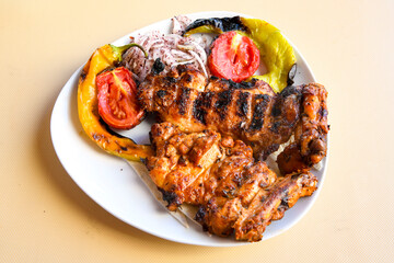 A skewered chicken kebob with grilled onions, bell peppers and delicious white meat with seasoning...