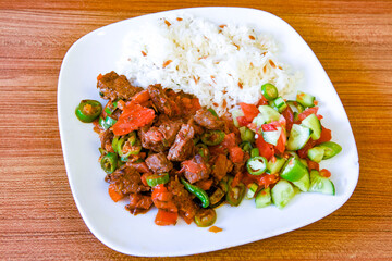 Beef steak grill with rice pilaf, fried potatoes, grilled pepper and tomatoes.Mix Platter with Beef rips, Cutlets, Potatoes and Sauces.