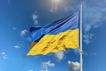 Flag of Ukraine on a background of blue sky. The largest flag in Ukraine.