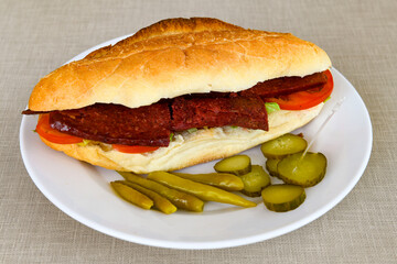 Close-up shot of Izmir's famous Turkish Traditional Kumru Sandwich, Çeşme Kumru, Karisik sandvic,  ingredients ready to eat salami, soudjouk, tomato, cheddar cheese and fried cheese. Yengen sandvic.