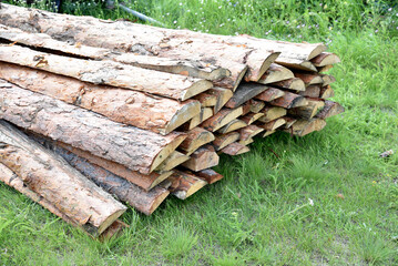 Warehouse of long pine planks in close-up during the day.