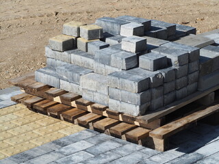 Obraz premium Paving stone laying works. Wooden pallets with paving stones. Improvement of city streets. Special paving stone for blind and visually impaired people