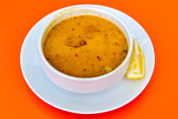 Lentil ( mercimek ) soup with melted butter and red pepper sauce. Mercimek corbasi