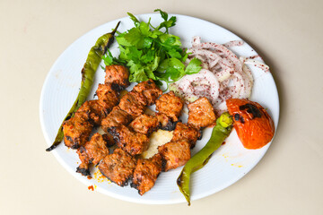 Chicken wings barbeque in a dish with BBQ sauce . Izgara tavuk sis kanat.