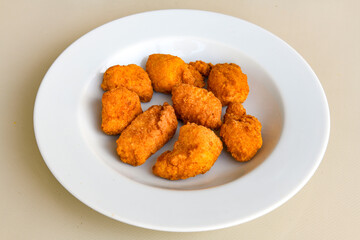 Fried Chicken breast hot crispy strips crunchy chicken tenders  isolated on white background.Nuggets isolated on white background on a plate