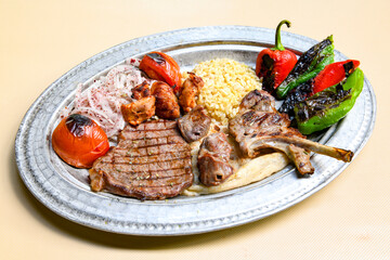 Beef steak grill with rice pilaf, fried potatoes, grilled pepper and tomatoes.Mix Platter with Beef rips, Cutlets, Potatoes and Sauces.