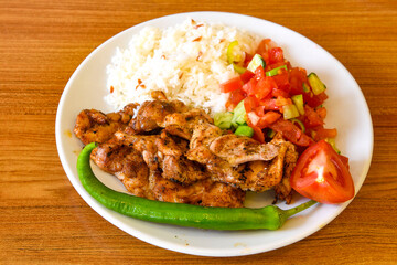 Chicken wings barbeque in a dish with BBQ sauce . Izgara tavuk sis kanat.