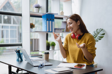 Young business women working and greeting on video conference with happy and smile face on office...