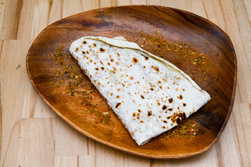 Freshly baked appetizing Turkish tortillas - Gozleme with spinach, cheese  on a wooden board. Space for text. Shallow depth of  field. Handmade Turkish traditional pastries.