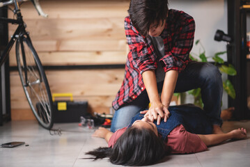 First aids emergency CPR on heart attack woman laying unconscious in home, One part of the process resuscitation - healthcare and insurance concept.