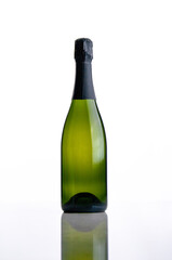 Bottle of champagne and a glass on a white background