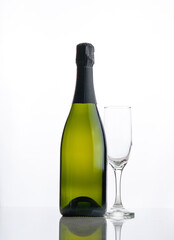 Bottle of champagne and a glass on a white background