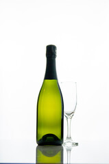 Bottle of champagne and a glass on a white background