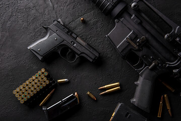 Gun with ammunition on table background. 