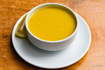 Lentil ( mercimek ) soup with melted butter and red pepper sauce. Mercimek corbasi