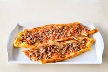Turkish pita with minced cubed meat and cheese (Turkish name: Kiyma Kusbasi kasarli pide)