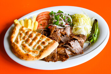 Turkish and Arabic Traditional Ramadan doner kebab with tasty tomato sauce and rice or turkish...
