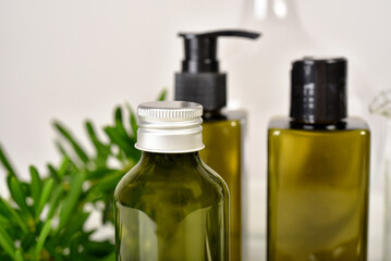 Natural skincare beauty product, Cosmetic green bottle containers packaging with green nature leaves, Blank label for organic spa branding mock-up, Herbal healthy skin care.