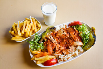 Turkish and Arabic Traditional Ramadan doner kebab with tasty tomato sauce and rice or turkish...