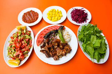 Beef steak grill with rice pilaf, fried potatoes, grilled pepper and tomatoes.Mix Platter with Beef rips, Cutlets, Potatoes and Sauces.