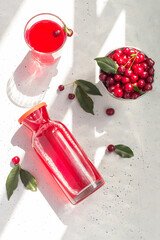 Cold cherry juice in a glass and bottle with ripe berries. Top view. The concept of summer...