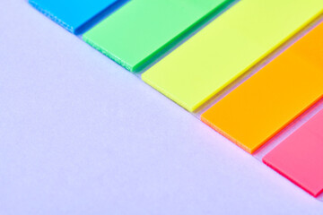 Close-up of colored pointing sticky notes for page marker