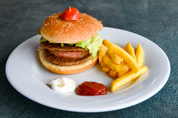 Big tasty  burger with beef cutlet on a plate. Hamburger.