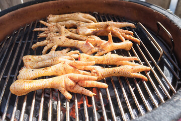 Grilled marinated chicken feet on BBQ