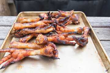 Grilled marinated chicken feet on BBQ
