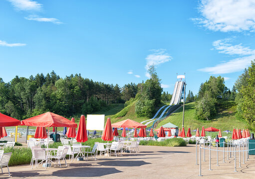 Empty water park with colorful slides and sun embrellas