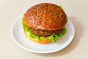 Big tasty  burger with beef cutlet on a plate. Hamburger.