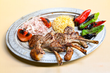Beef steak grill with rice pilaf, fried potatoes, grilled pepper and tomatoes.Mix Platter with Beef rips, Cutlets, Potatoes and Sauces.