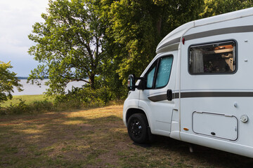 Camper van on a natural campsite at the lake in Sweden.