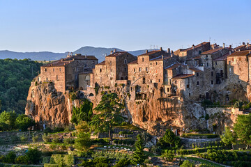 Medieval stone buildings on a rocky cliff in the town of Pitigliano