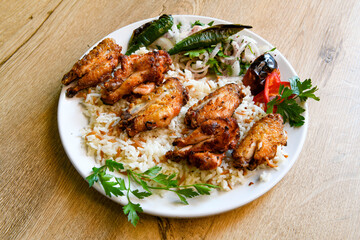 A skewered chicken kebob with grilled onions, bell peppers and delicious white meat with seasoning isolated on a white background. Tavuk sis, Tavuk izgara.