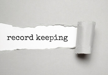 RECORD KEEPING text on white torn paper