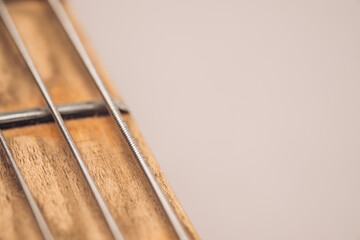 Electric guitar steel strings with fretboard background. Instrument playing minimal backdrop.