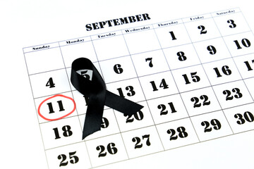 Calendar with marked day of terrorist attacks and black tie