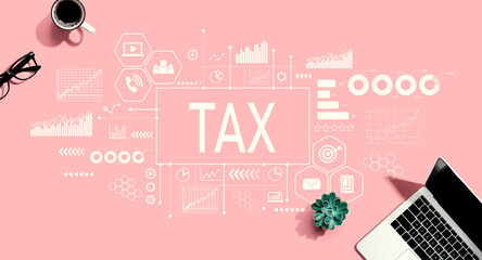 Tax theme with a laptop computer on a pink background