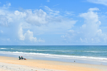 Couple enjoying a beautiful day at a quiet beach near Palm Coast, Florida between Flagler Beach and St. Augustine. 
