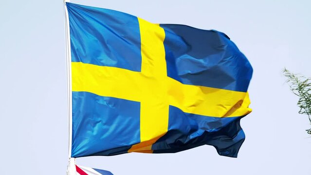flag of Sweden. Sweden's national symbols. Swedish flag on a flagpole against the sky. European country flag